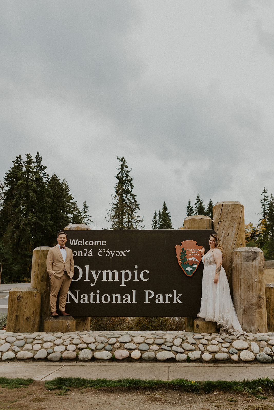 Eloping couple with Olympic National Park welcome sign