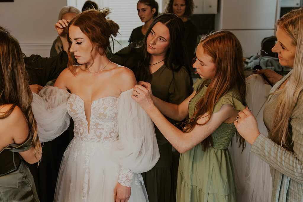 Friends and family helping bride get ready for wedding