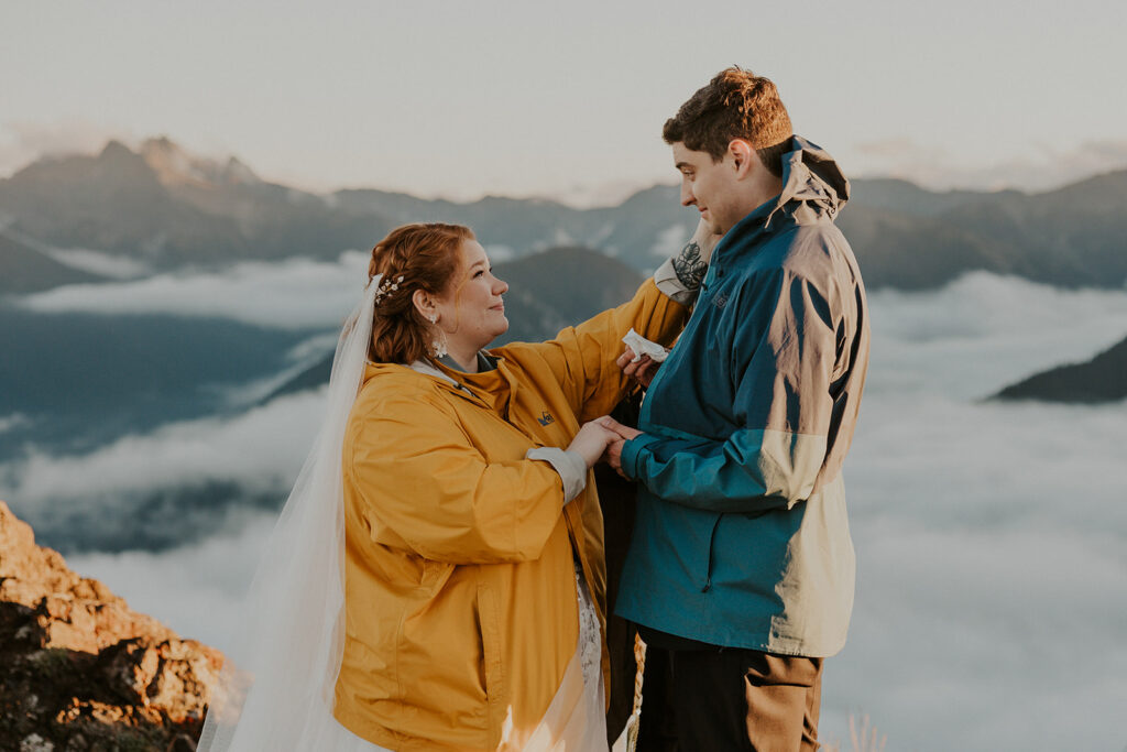 A couple in wedding attire have a wedding ceremony at Hurricane Ridge in Olympic National Park