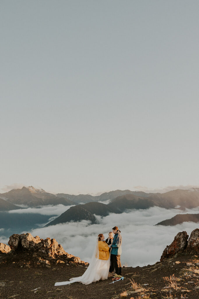 A couple in wedding attire have a wedding ceremony at Hurricane Ridge in Olympic National Park