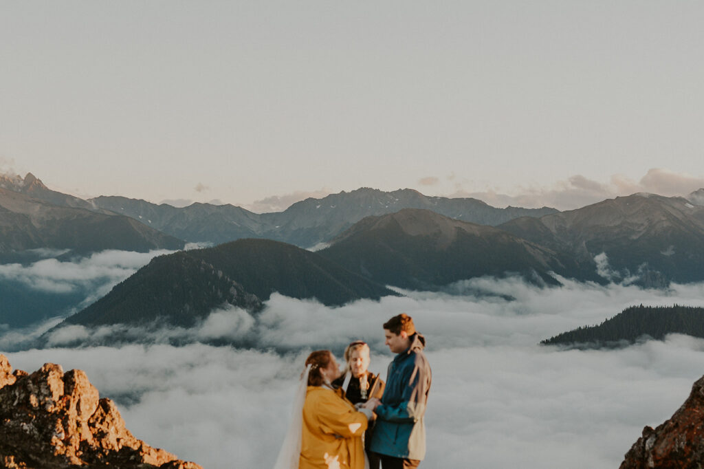 A couple in wedding attire have a wedding ceremony at Hurricane Ridge in Olympic National Park