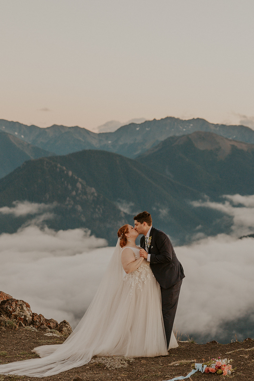 A couple in wedding attire poses for portraits at Hurricane Ridge in Olympic National Park