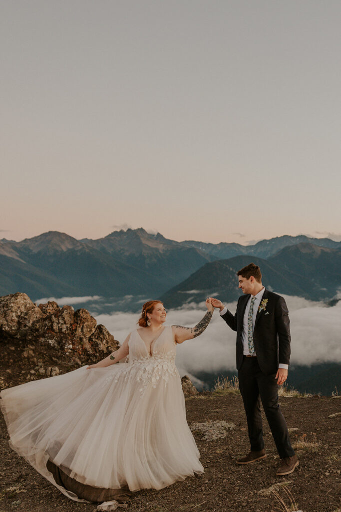 A couple in wedding attire poses for portraits at Hurricane Ridge in Olympic National Park