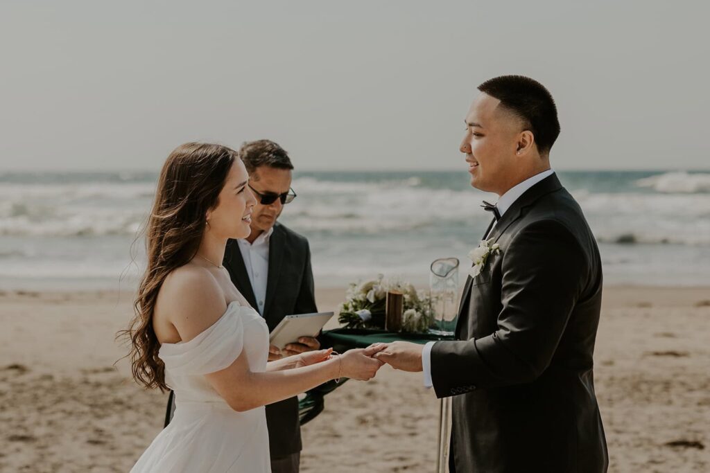 Couple exchanging rings during their micro wedding on the Oregon Coast