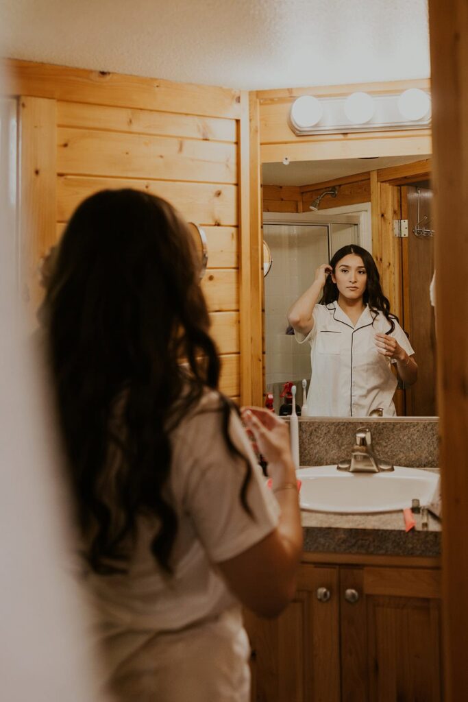 Bride getting ready in the mirror