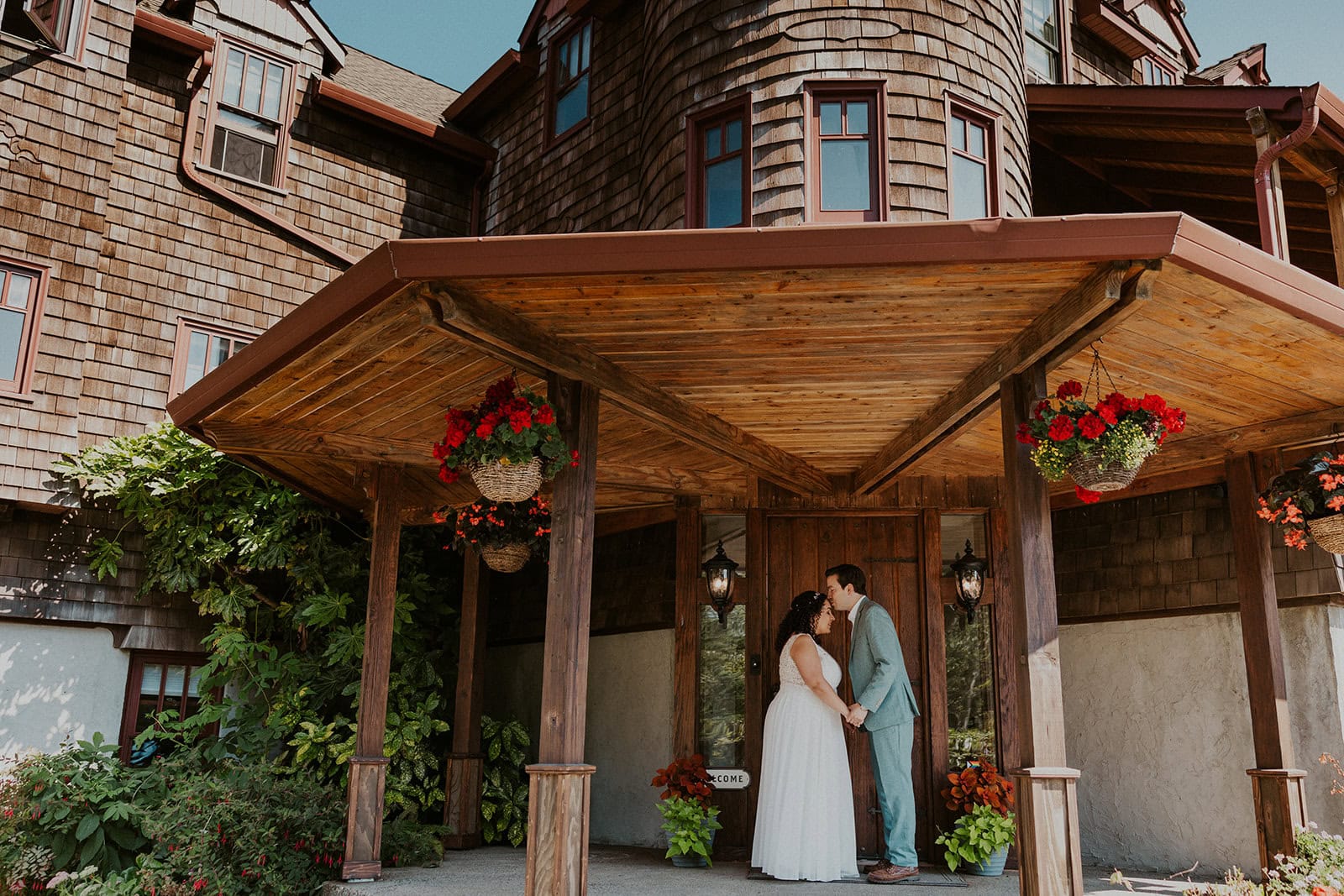 An eloping couple stands in front of Arch Cape Inn in Cannon Beach, OR