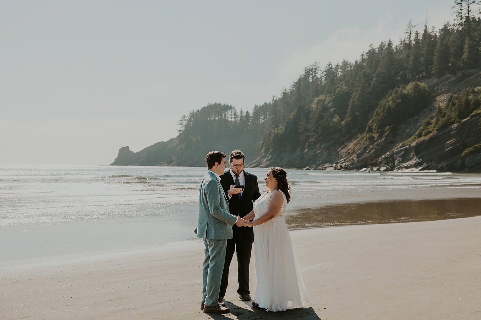 A couple exchanging vows at Short Sand Beach on the Oregon Coast during their elopement day