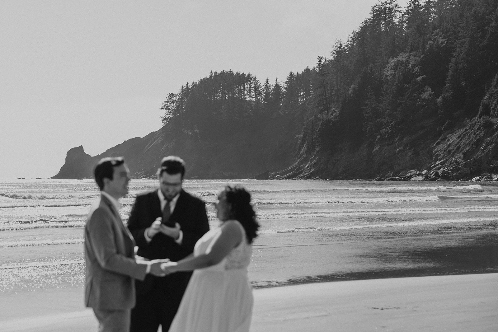 A couple exchanging vows at Short Sand Beach on the Oregon Coast during their elopement day