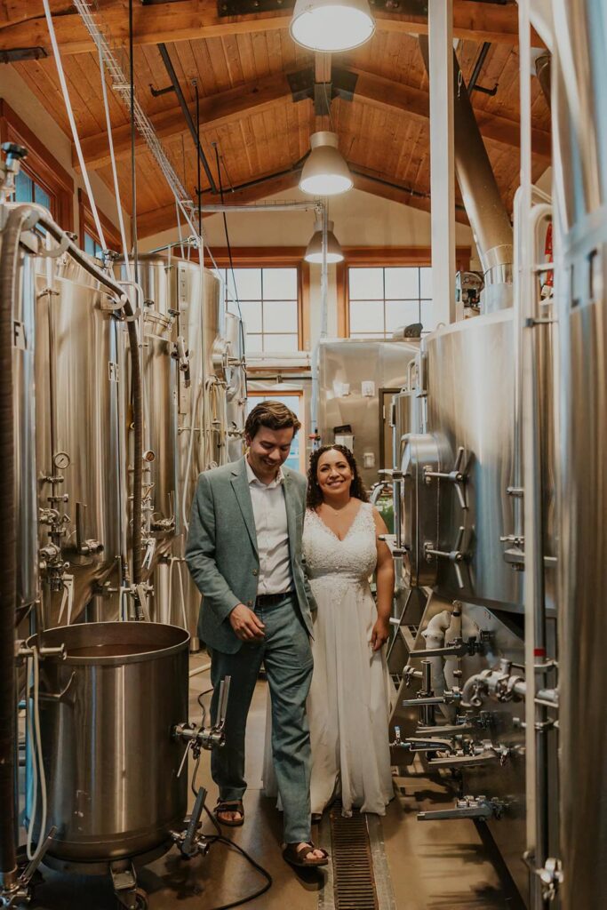 A couple having drinks together at Pelican Brewing in Cannon Beach during their elopement day