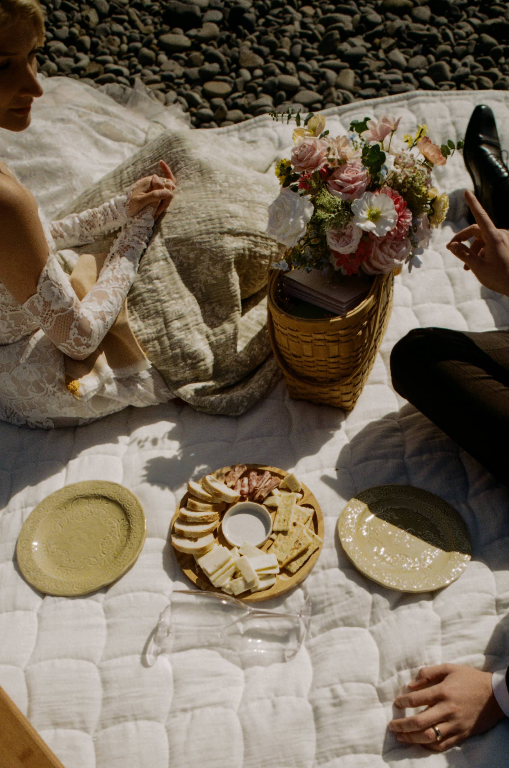 A couple shares a beach picnic during their elopement day on the Oregon Coast on 35mm film