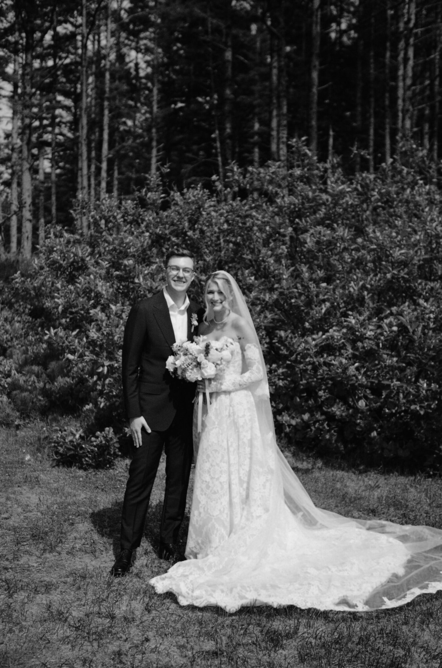 A couple posing after their elopement ceremony, captured on film in black and white