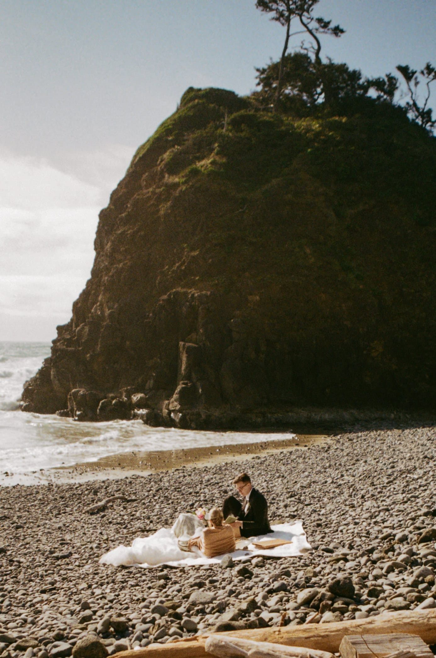 A couple exchange vows on an Oregon Coast beach during their elopement day on 35mm film