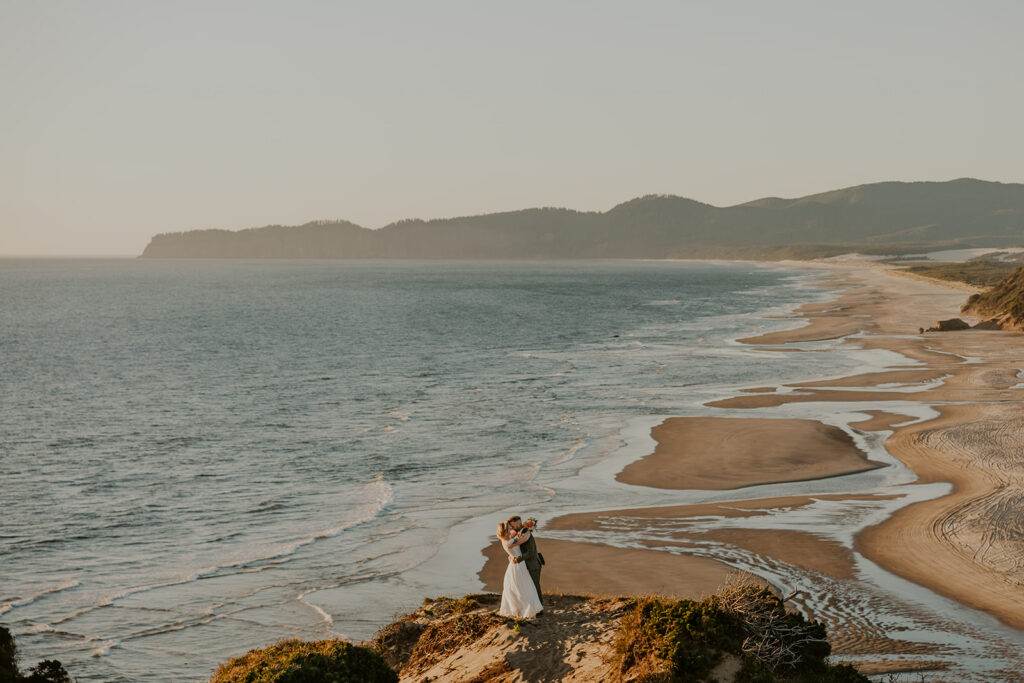 A couple overlooking the Oregon Coast on their elopement day