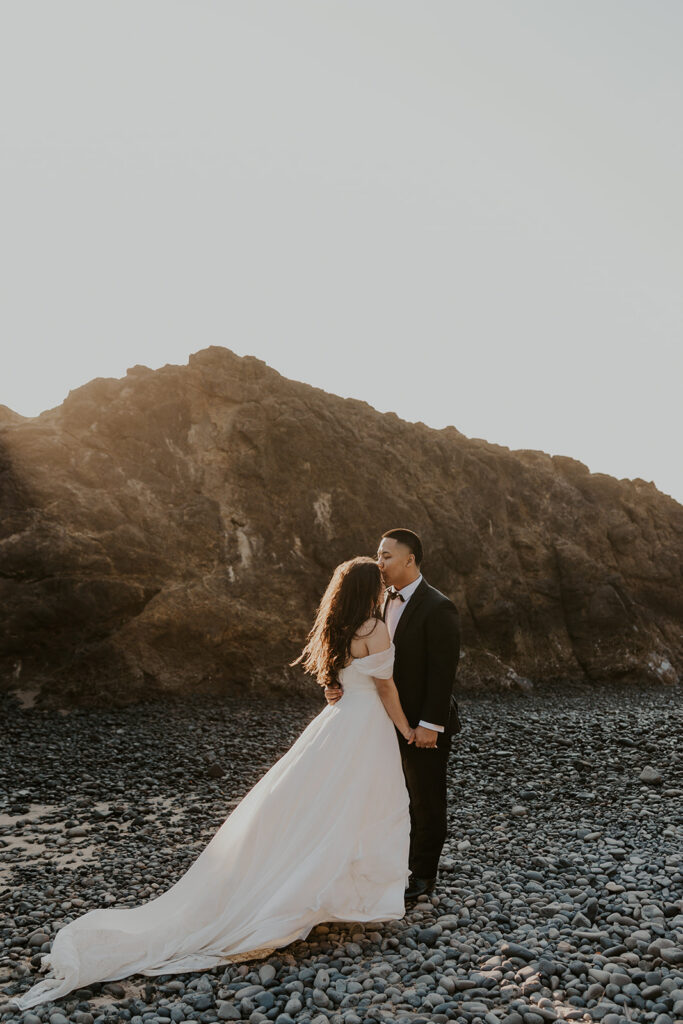 A couple on an Oregon Coast beach during their elopement