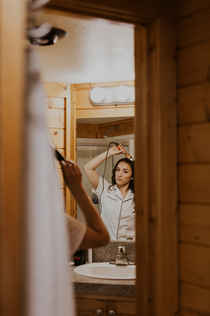 A bride curling her hair before her Oregon Coast elopement